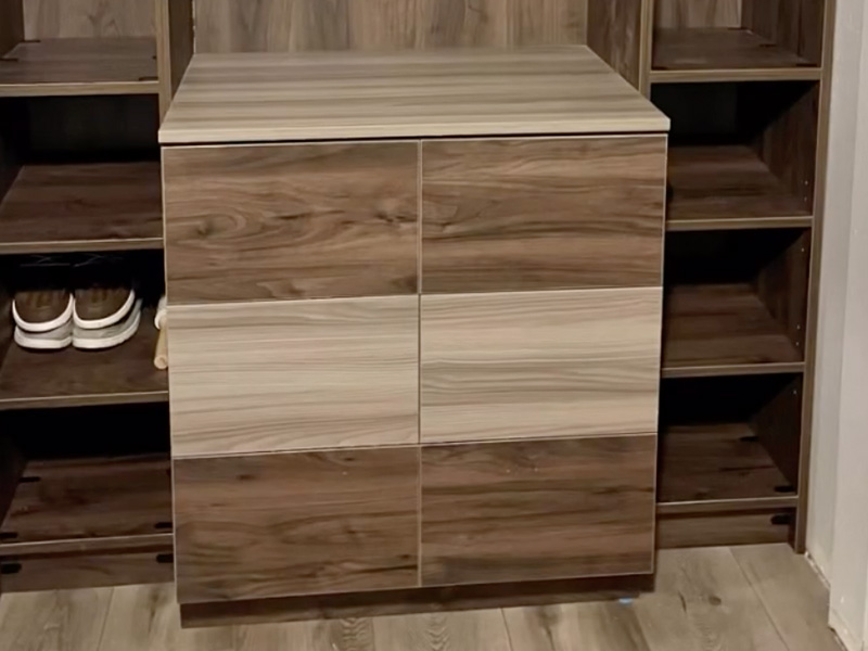 Detailed view of mudroom cabinet design features including family cubbies, bench seating, and organization systems